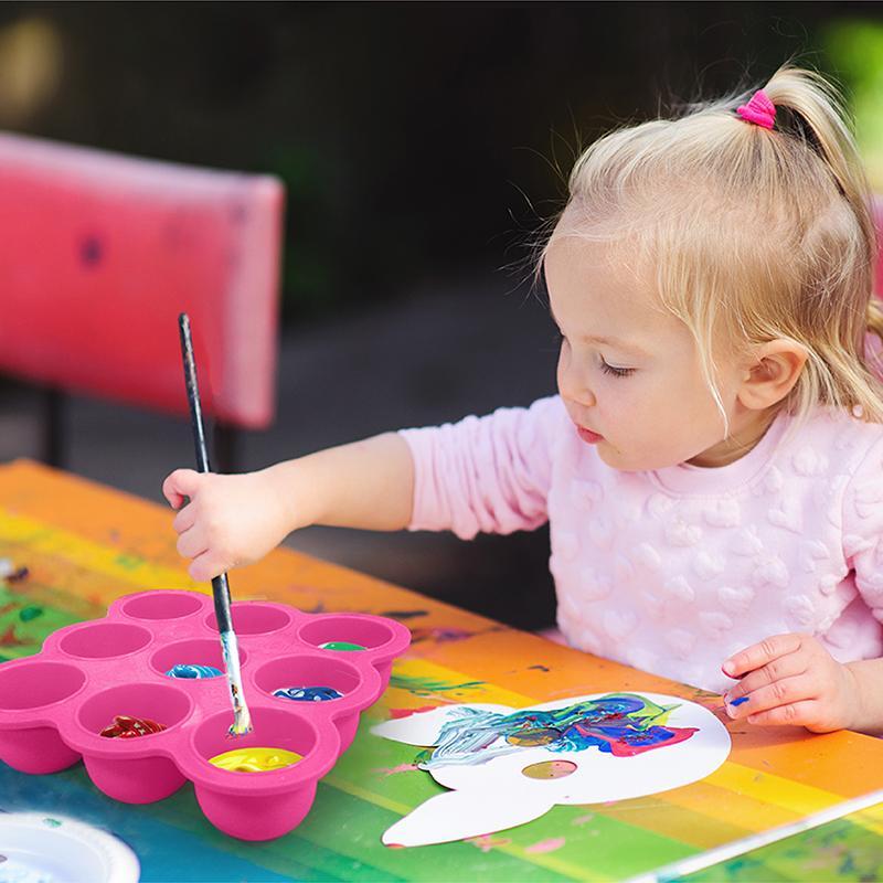 baby girl mixing colours on silicone tray